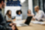 Mixed group of office professionals in a boardroom meeting 