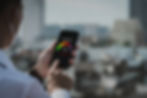 Man using an AQI app on his phone to see what the air quality status is