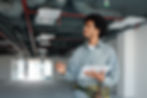 Young black male maintenance technician with a clipboard checking off inspecting the HVAC system performance