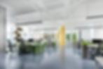 Bright white office interior with exposed ducting and a lot of natural light