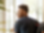 Image of your African American male student with a black tshirt and black backpack looking out of a window